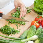 Knife chopping cilantro with veggies